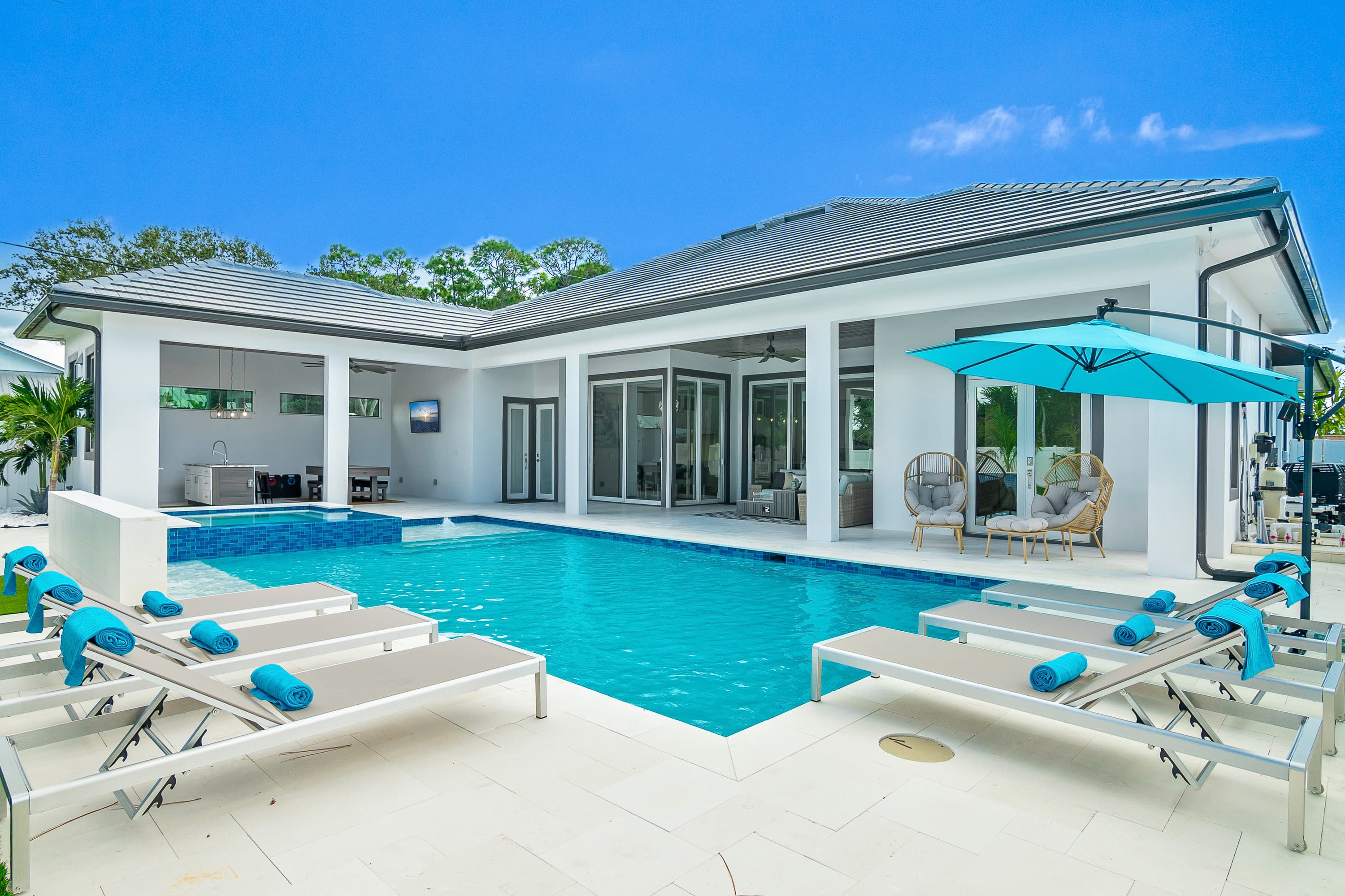Pool area with loungers and umbrella